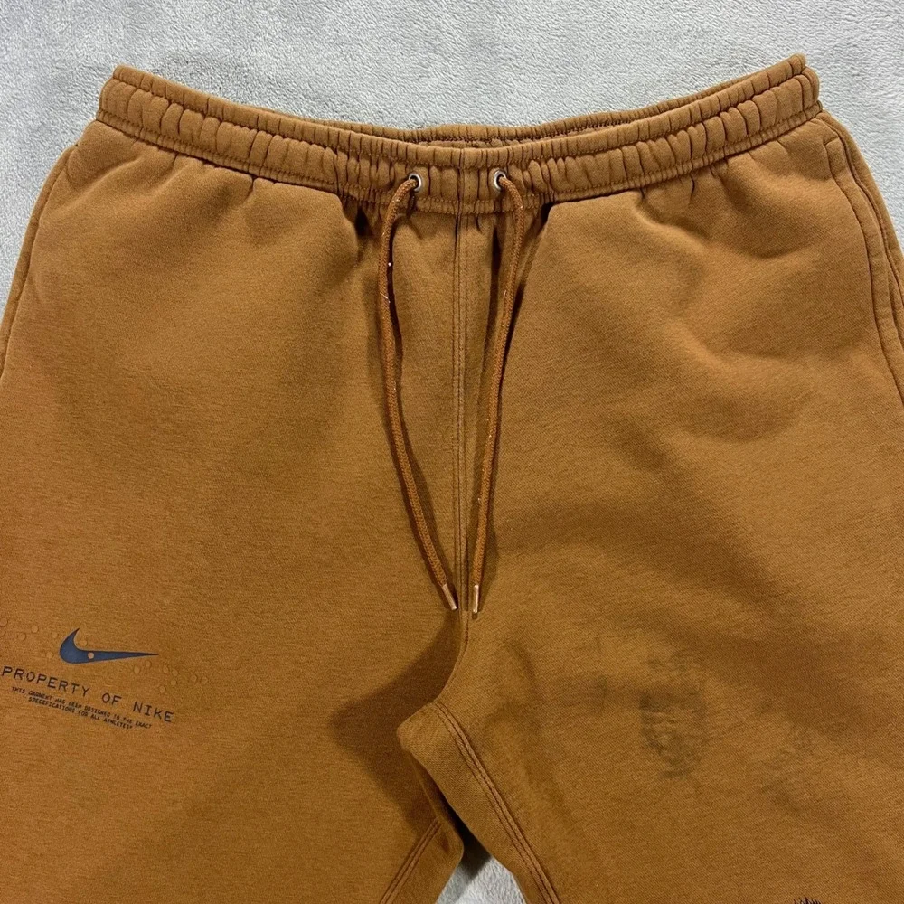 NIKE‎ Sportswear Club Cuffed Fleece Pants Mens Large Brown IM7828-235 Graphic